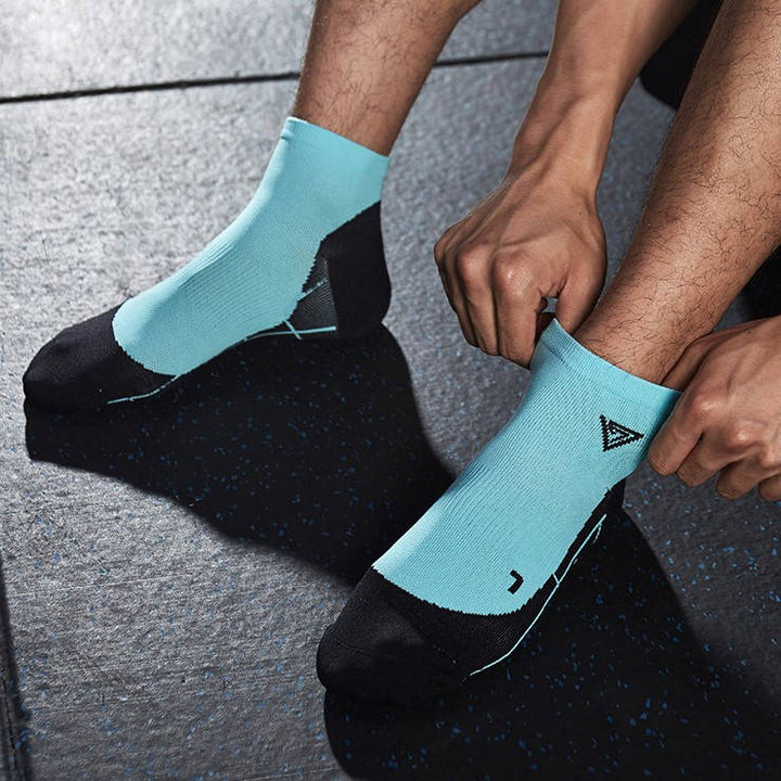 Aqua blue fitness socks with cushioned sole and snug fit for all-day workout comfort.
