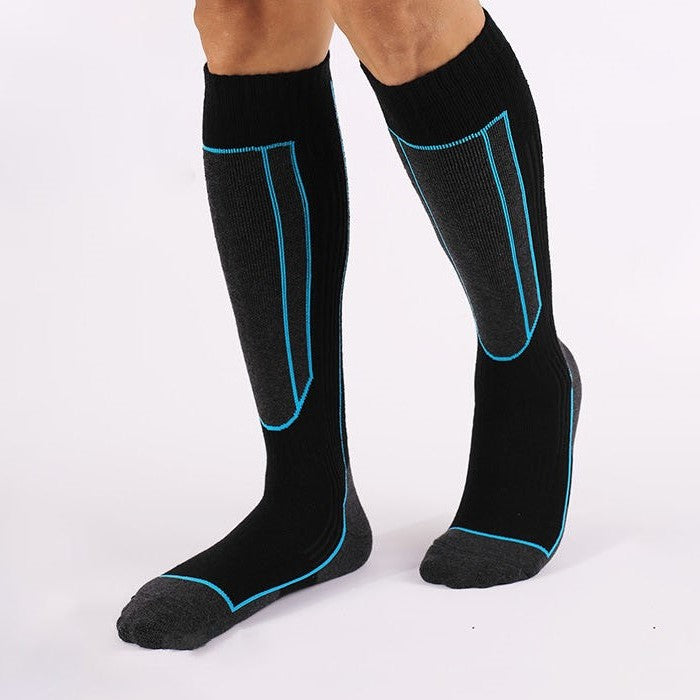 Athlete wearing black Merino wool over the calf skiing socks for superior comfort during winter sports