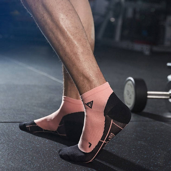 Athlete wearing pink fitness socks with breathable fabric, perfect for gym and strength workouts.