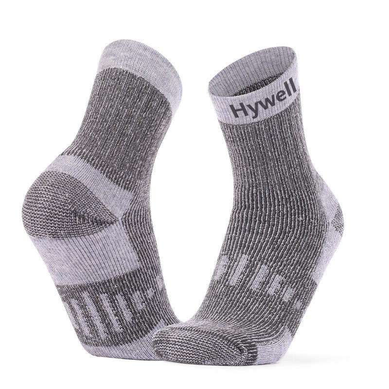 Breathable Merino wool crew socks for running, featuring reinforced heel and toe in grey and white