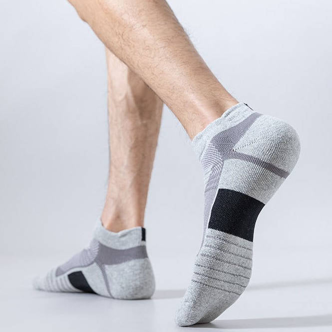 Close-up of gray cushioned socks for walking, designed with arch support and a snug fit for stability.