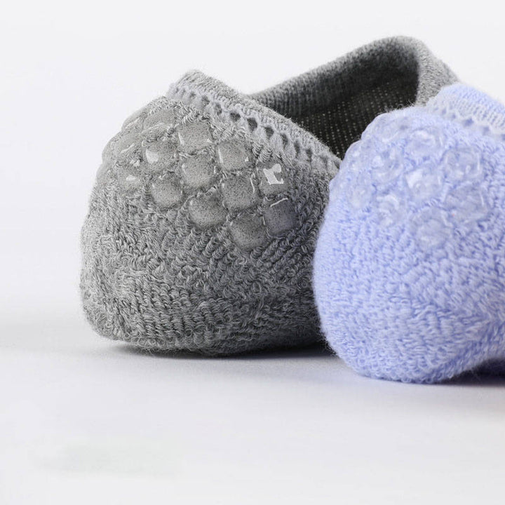 Close-up of grey cushioned no-show socks with anti-slip silicone for everyday wear.