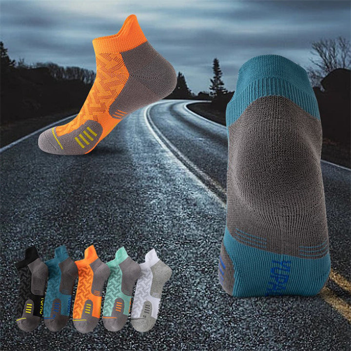 Gray and teal running socks with reinforced heel and toe for added durability and comfort during workouts.