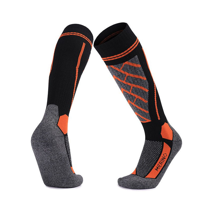 Merino Wool Skiing Over The Calf Socks in black with orange accents, high-performance socks for mountain slopes