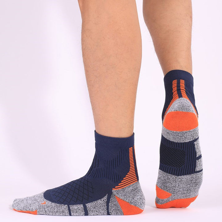 Navy and orange cushioned tennis socks with added padding for impact absorption, perfect for quick lateral movements.