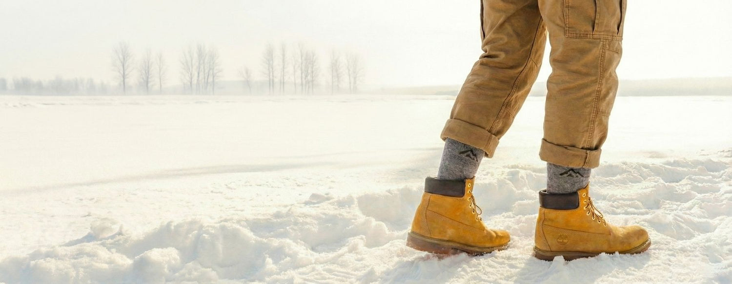 Walking in snow with Timberland waterproof boots and thick wool socks for winter warmth