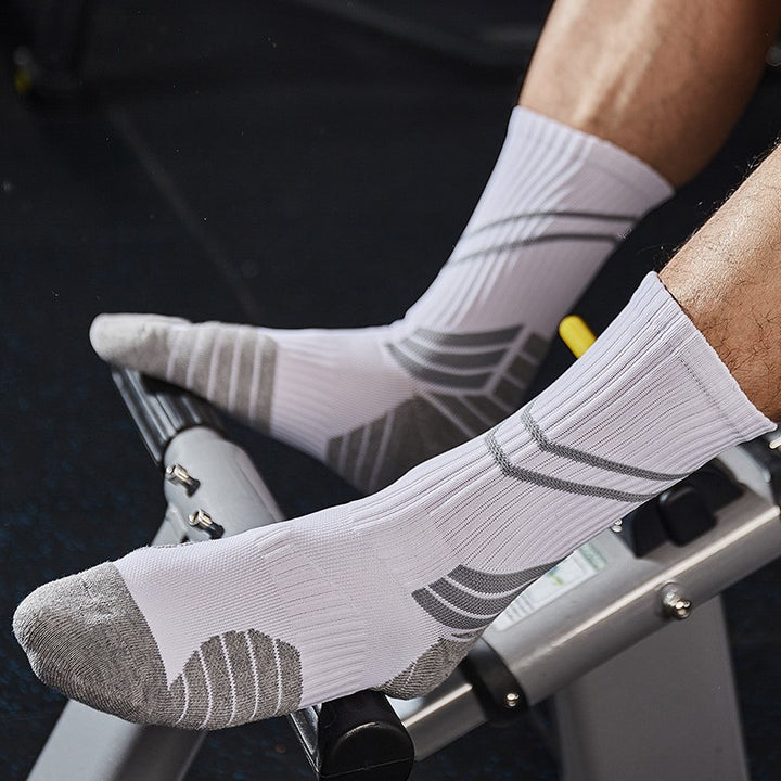 White and gray fitness socks in use on gym equipment, built for performance and comfort.