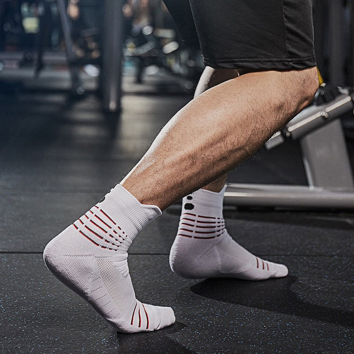 White fitness socks in use at the gym, offering breathable mesh and cushioned sole for active performance.