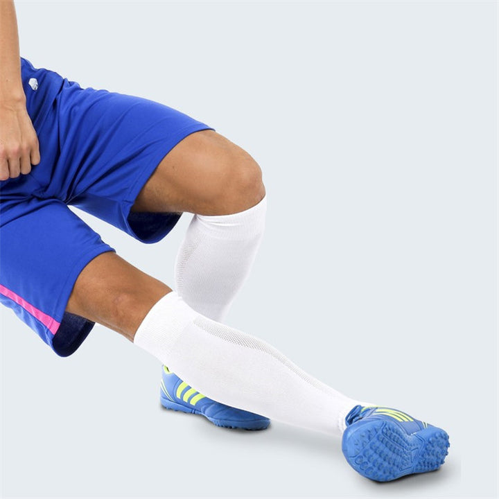 White over-the-calf padded soccer socks in action, designed for comfort and support on the field.