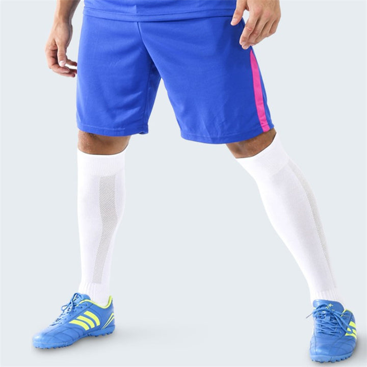 White padded soccer socks worn during play, offering shin coverage and impact absorption.