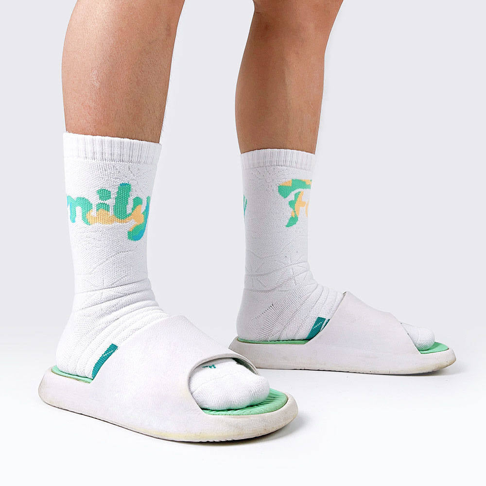 White padded socks with green details, offering arch support and padding for walking or workouts.