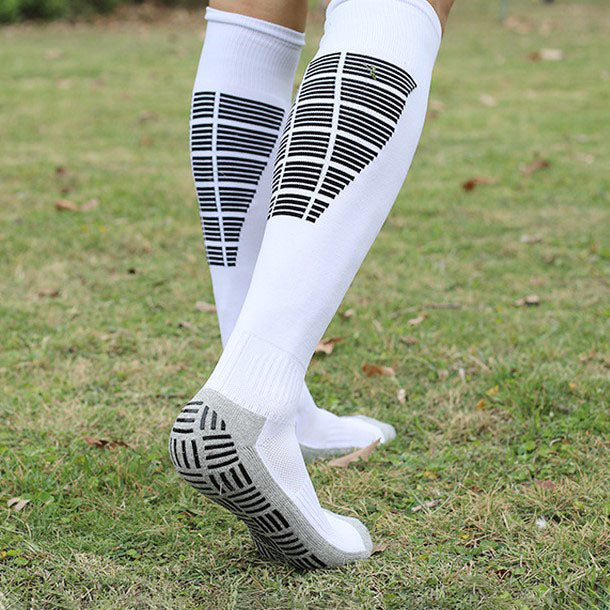 White soccer grip socks featuring padded soles for improved comfort.