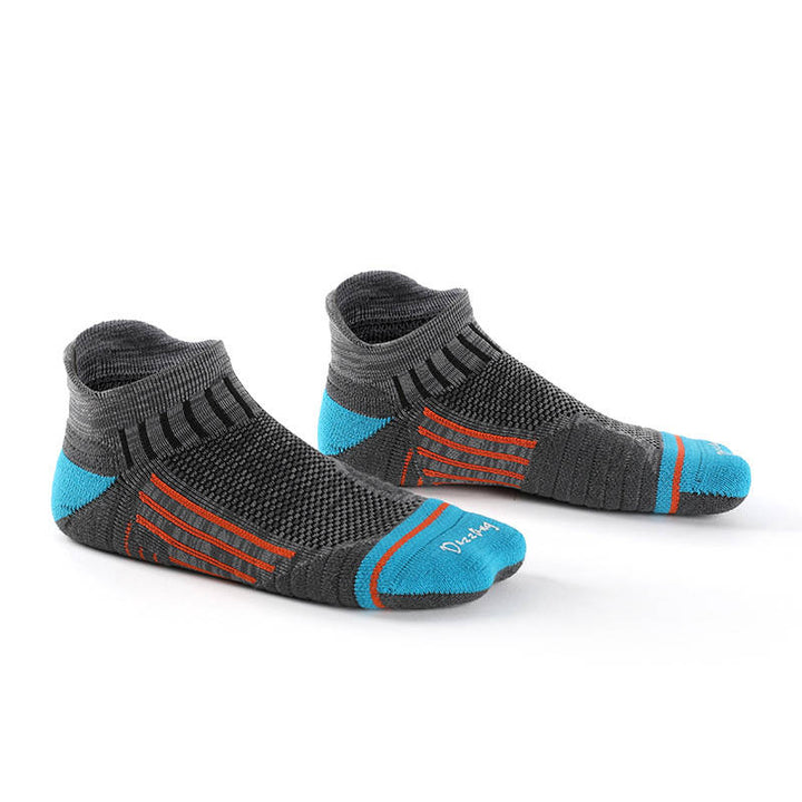 Dark gray compression running socks with orange accents, offering compression and comfort for running enthusiasts.