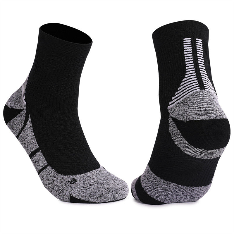 Black and gray cushioned tennis socks with a comfortable fit, designed for stability and performance on the court.