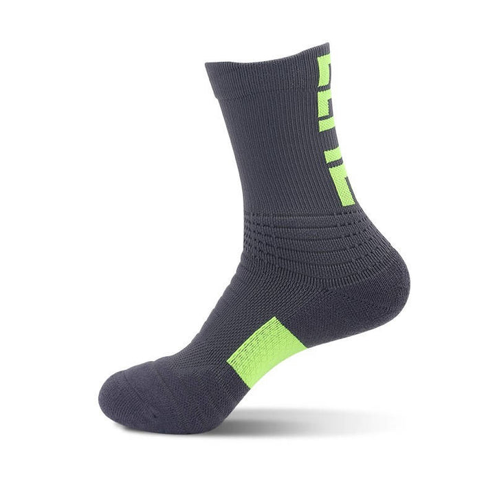 Dark gray fitness socks with green heel accents, ideal for dynamic movement and ankle stability.