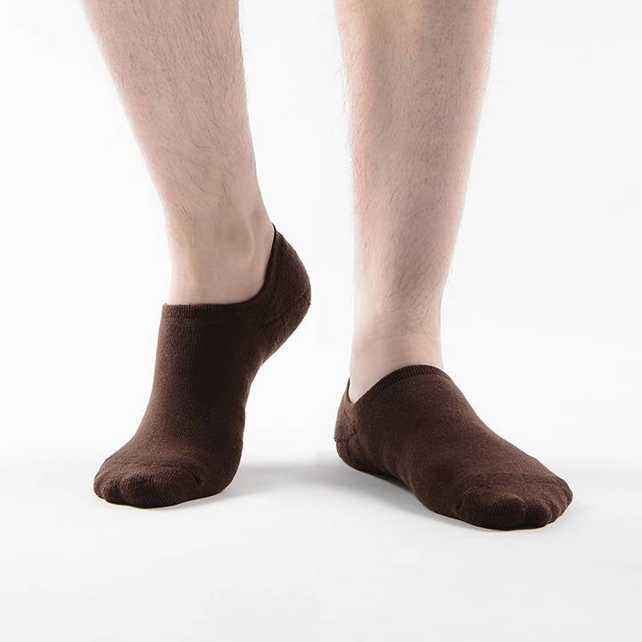 Man wearing cushioned no-show socks in a neutral tone.