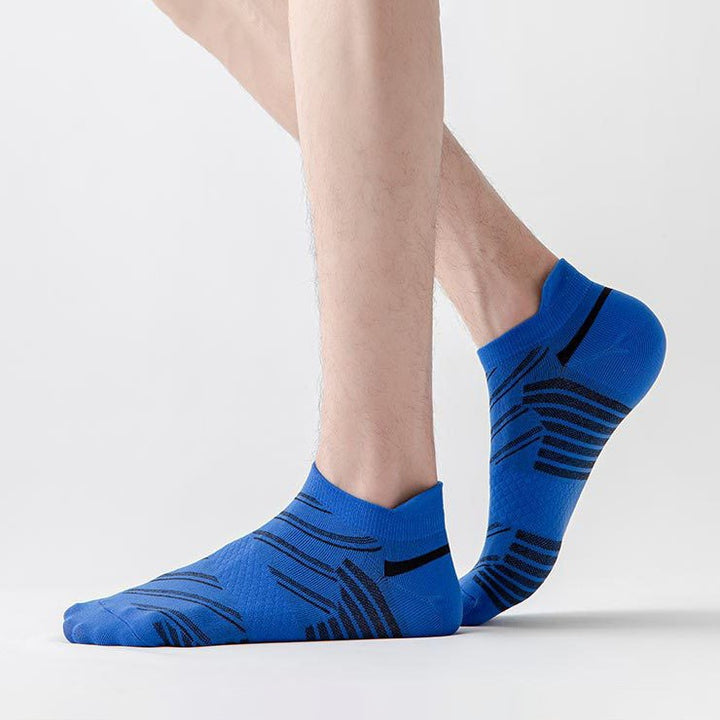 Person wearing vibrant blue ankle socks with black stripe design against a white background.